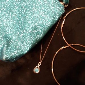 Sparkly turquoise handbag with hoops and necklace